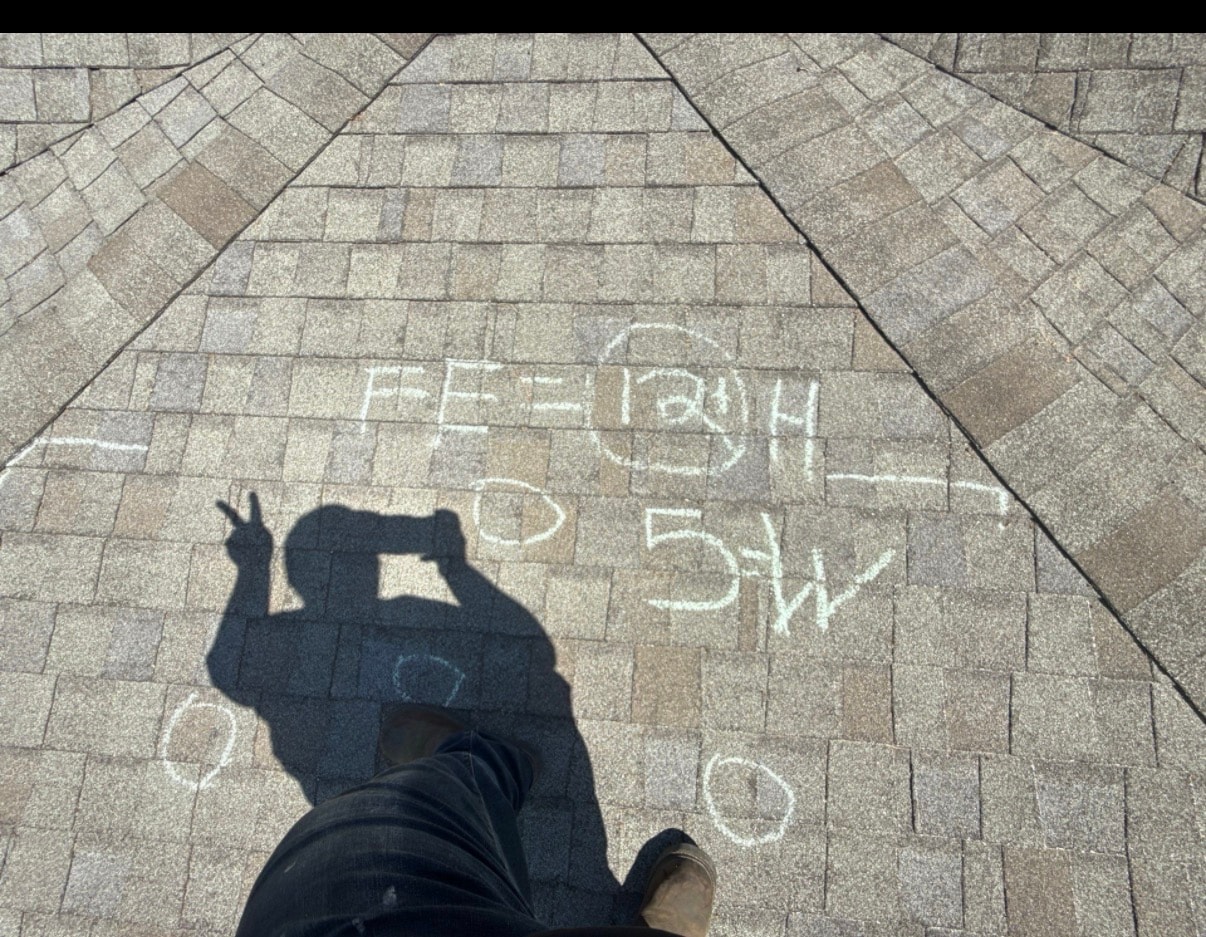 Jill conducting a roof inspection with chalk damage markings