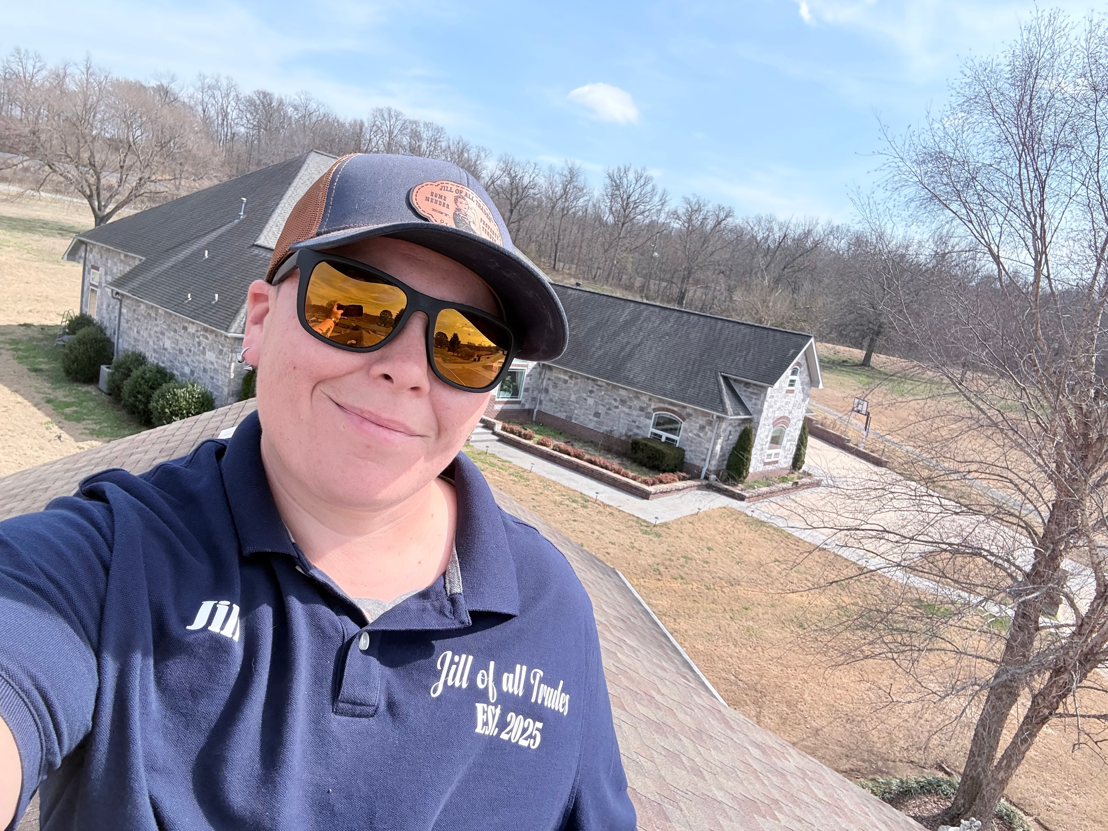 Jill standing on a client's roof, surveying storm damage that the insurance company denied